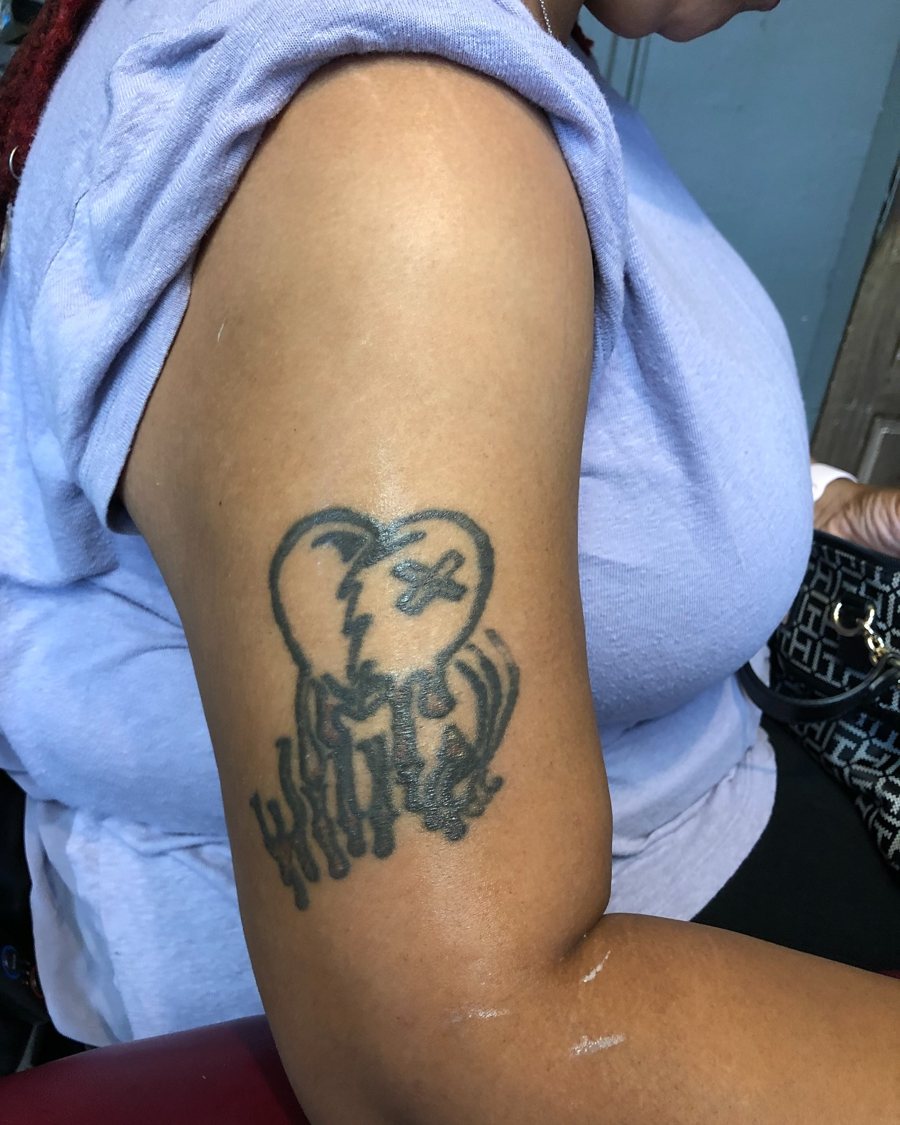 Existing upper-arm tattoo photographed before a cover-up consultation